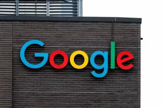 Colorful Google logo displayed on a brick wall of a building