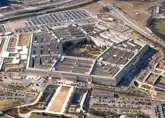 Aerial view of the Pentagon building surrounded by parking lots and roadways.