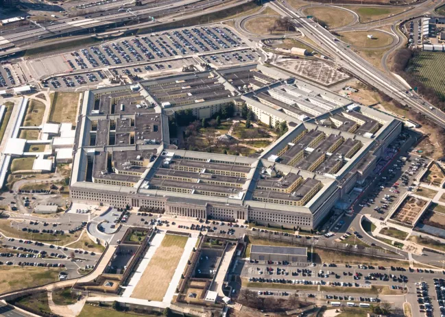 Aerial view of the Pentagon building surrounded by parking lots and roadways.