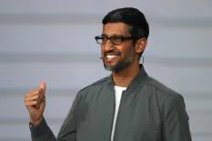 Sundar Pichai smiling and giving a thumbs up during a presentation
