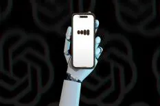 robot hand holding smartphone