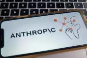 Mobile phone displaying the AnthropiC logo, featuring a graphic of a hand interacting with connected nodes.